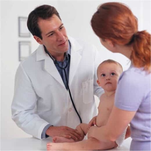 Doctor talking to mother after examining baby